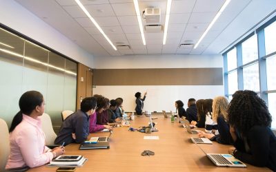 Business meeting with diverse team discussing projects in a modern conference room.
