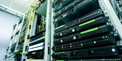 High-tech server rack in a secure data center with network cables and hardware components.