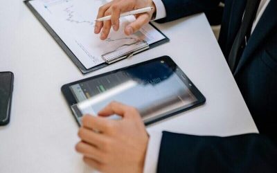 Business professionals working with tablet and documents in a modern office.